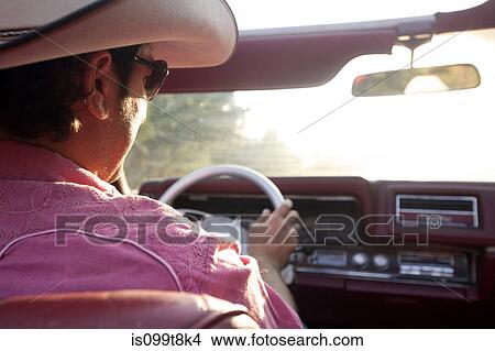 Man in a cowboy hat driving a convertible View Large Photo Image Picture - Man in a cowboy hat driving a convertible. Fotosearch