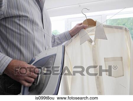 Man with shirt and iron View Large Photo Image Stock Photograph - Man with shirt and iron. Fotosearch