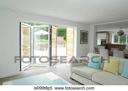 Stock Photography - Open plan living area with open patio doors. Fotosearch