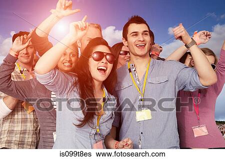 People cheering at a music festival View Large Photo Image Stock Photograph - People cheering at a music festival. Fotosearch