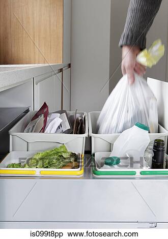 Person removing rubbish bag from waste and recycling drawer View Large Photo Image Stock Photography - Person removing rubbish bag from waste and recycling drawer. Fotosearch