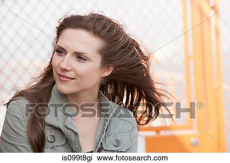 Portrait of a young woman outdoors View Large Photo Image Stock Image - Portrait of a young woman outdoors. Fotosearch