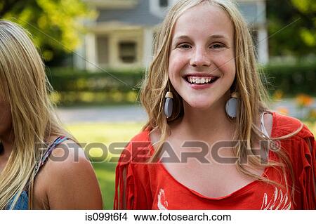 Picture - Portrait of blonde girl wearing earrings smiling to camera. Fotosearch