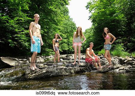 Portrait of friends by river View Large Photo Image Stock Photography - Portrait of friends by river. Fotosearch