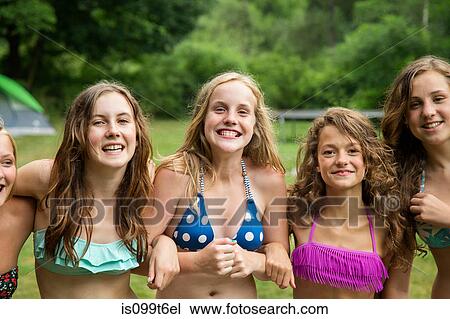 Stock Image - Portrait of girls wearing bikini tops. Fotosearch