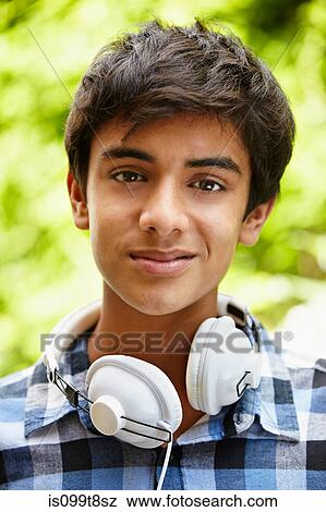 Stock Photo - Portrait of teenage boy with headphones. Fotosearch