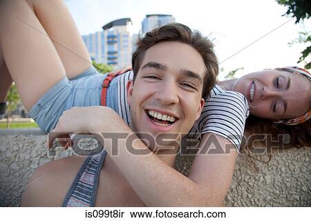 Portrait of young couple, woman with arm around man View Large Photo Image Stock Photography - Portrait of young couple, woman with arm around man. Fotosearch