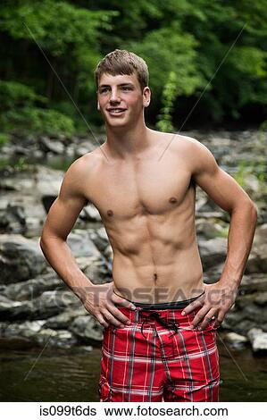 Stock Photograph - Portrait of young man by river. Fotosearch