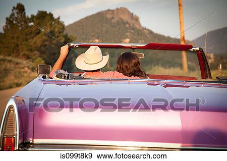 Rear view of couple in convertible car View Large Photo Image Stock Photo - Rear view of couple in convertible car. Fotosearch