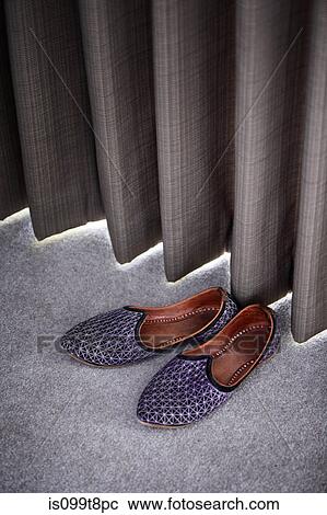 Stock Image - Slippers by a curtain. Fotosearch