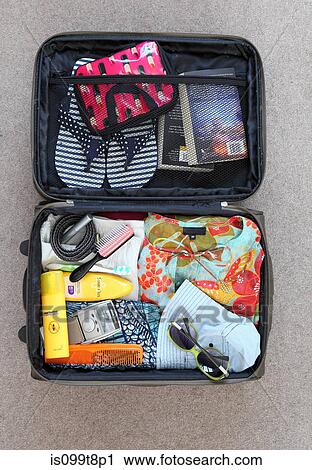 Suitcase packed for vacation View Large Photo Image Stock Image - Suitcase packed for vacation. Fotosearch