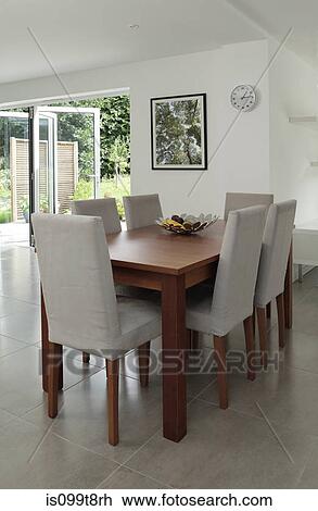 Stock Image - Table and chairs in dining area. Fotosearch