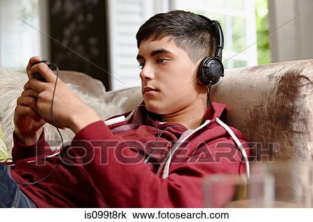 Teenage boy listening to music View Large Photo Image Stock Image - Teenage boy listening to music. Fotosearch