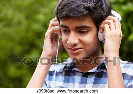 Teenage boy listening to music View Large Photo Image Stock Image - Teenage boy listening to music. Fotosearch