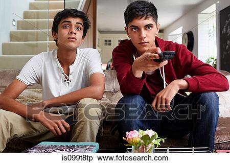 Teenage boys watching television View Large Photo Image Stock Photography - Teenage boys watching television. Fotosearch
