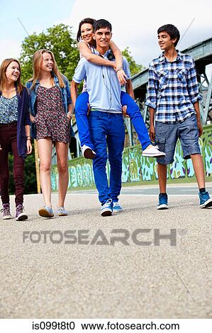 Teenage friends walking View Large Photo Image Stock Image - Teenage friends walking. Fotosearch