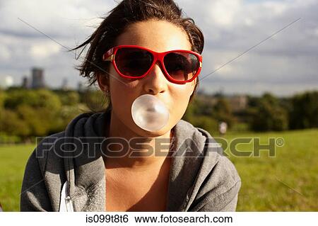 Teenage girl in sunglasses, blowing bubble gum View Large Photo Image Stock Photograph - Teenage girl in sunglasses, blowing bubble gum. Fotosearch
