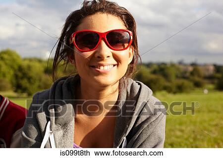 Teenage girl in sunglasses in the park View Large Photo Image Stock Image - Teenage girl in sunglasses in the park. Fotosearch
