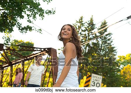 Teenage girl on bridge with friends View Large Photo Image Stock Image - Teenage girl on bridge with friends. Fotosearch
