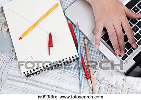 Teenage girl using laptop with notepad and pencils View Large Photo Image Stock Photo - Teenage girl using laptop with notepad and pencils. Fotosearch