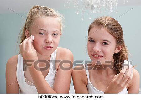 Teenage girls cleansing their faces View Large Photo Image Stock Photo - Teenage girls cleansing their faces. Fotosearch