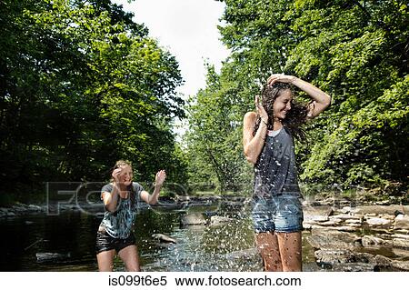 Teenage girls playing in river View Large Photo Image Stock Photography - Teenage girls playing in river. Fotosearch