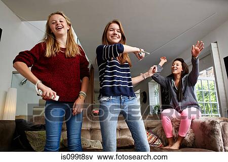 Stock Photo - Teenage girls playing video game. Fotosearch