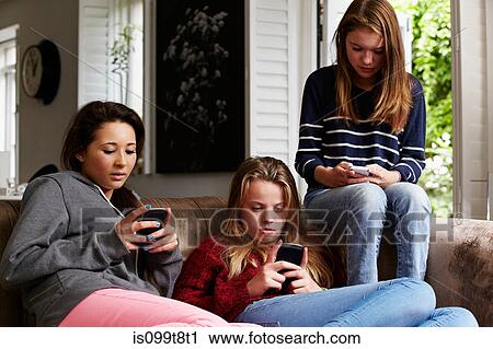 Teenage girls using cellphones View Large Photo Image Stock Image - Teenage girls using cellphones. Fotosearch