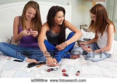 Teenage girls using nail polishes View Large Photo Image Stock Photo - Teenage girls using nail polishes. Fotosearch