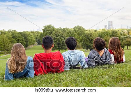 Teenagers hanging out in a park View Large Photo Image Stock Photograph - Teenagers hanging out in a park. Fotosearch