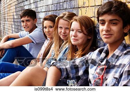 Picture - Teenagers sitting in a row. Fotosearch