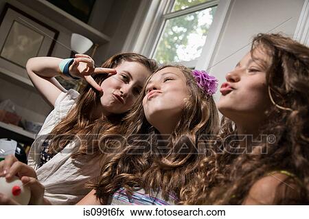 Three girls pulling faces View Large Photo Image Stock Photo - Three girls pulling faces. Fotosearch