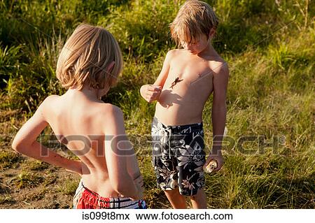 Two boys, one with a frog on his chest View Large Photo Image Stock Photo - Two boys, one with a frog on his chest. Fotosearch