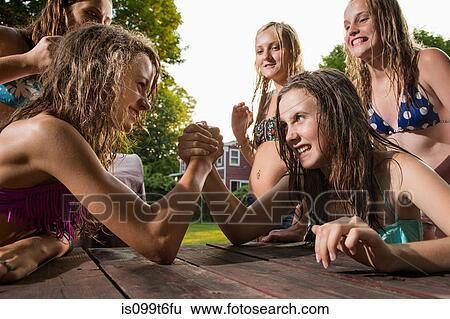 Stock Photograph - Two girls arm wrestling. Fotosearch