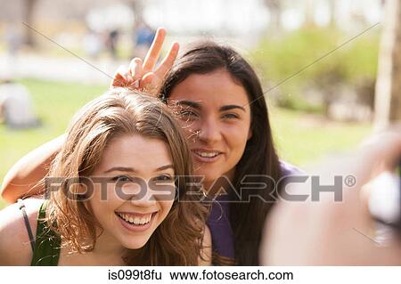 Stock Photograph - Two young women having their picture taken. Fotosearch