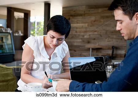 Woman and man working in a cafe View Large Photo Image Stock Image - Woman and man working in a cafe. Fotosearch