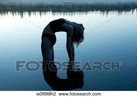 Woman bending backwards in lake View Large Photo Image Stock Image - Woman bending backwards in lake. Fotosearch