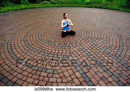 Woman meditating in paving stone circles View Large Photo Image Stock Image - Woman meditating in paving stone circles. Fotosearch