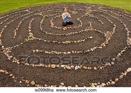 Woman meditating in stone labyrinth View Large Photo Image Stock Image - Woman meditating in stone labyrinth. Fotosearch