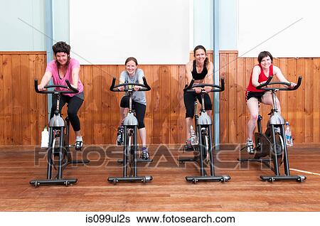 Women in spinning class View Large Photo Image Stock Photograph - Women in spinning class. Fotosearch