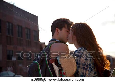 Stock Photograph - Young couple kissing. Fotosearch