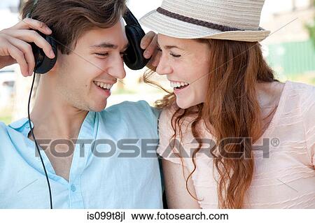 Stock Image - Young couple listening to music. Fotosearch