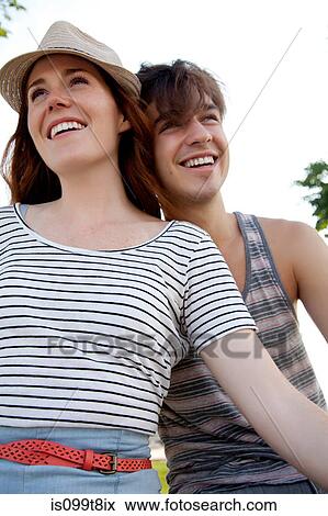 Young couple looking away, portrait View Large Photo Image Stock Photo - Young couple looking away, portrait. Fotosearch