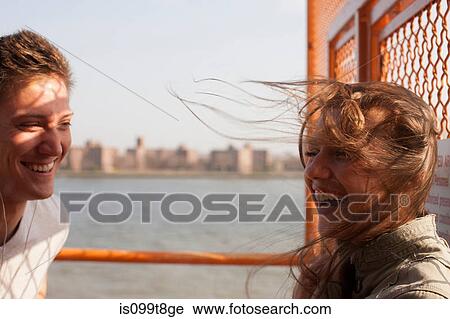 Young couple on a ferry, wind blowing hair View Large Photo Image Stock Image - Young couple on a ferry, wind blowing hair. Fotosearch