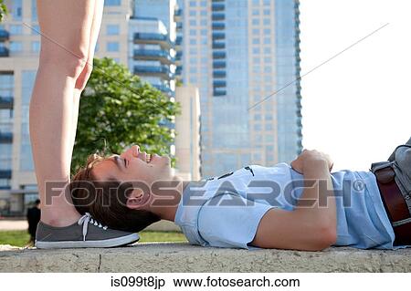 Young couple on wall, woman standing above man View Large Photo Image Stock Photography - Young couple on wall, woman standing above man. Fotosearch