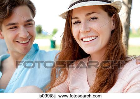 Young couple smiling, portrait View Large Photo Image Stock Image - Young couple smiling, portrait. Fotosearch