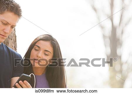 Young man and young woman with smartphone View Large Photo Image Picture - Young man and young woman with smartphone. Fotosearch
