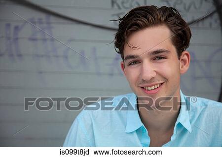 Stock Image - Young man smiling, portrait. Fotosearch