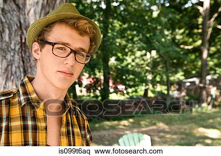Young man wearing eyeglasses and fedora View Large Photo Image Stock Photography - Young man wearing eyeglasses and fedora. Fotosearch