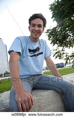 Young man wearing jeans and t shirt, portrait View Large Photo Image Picture - Young man wearing jeans and t shirt, portrait. Fotosearch